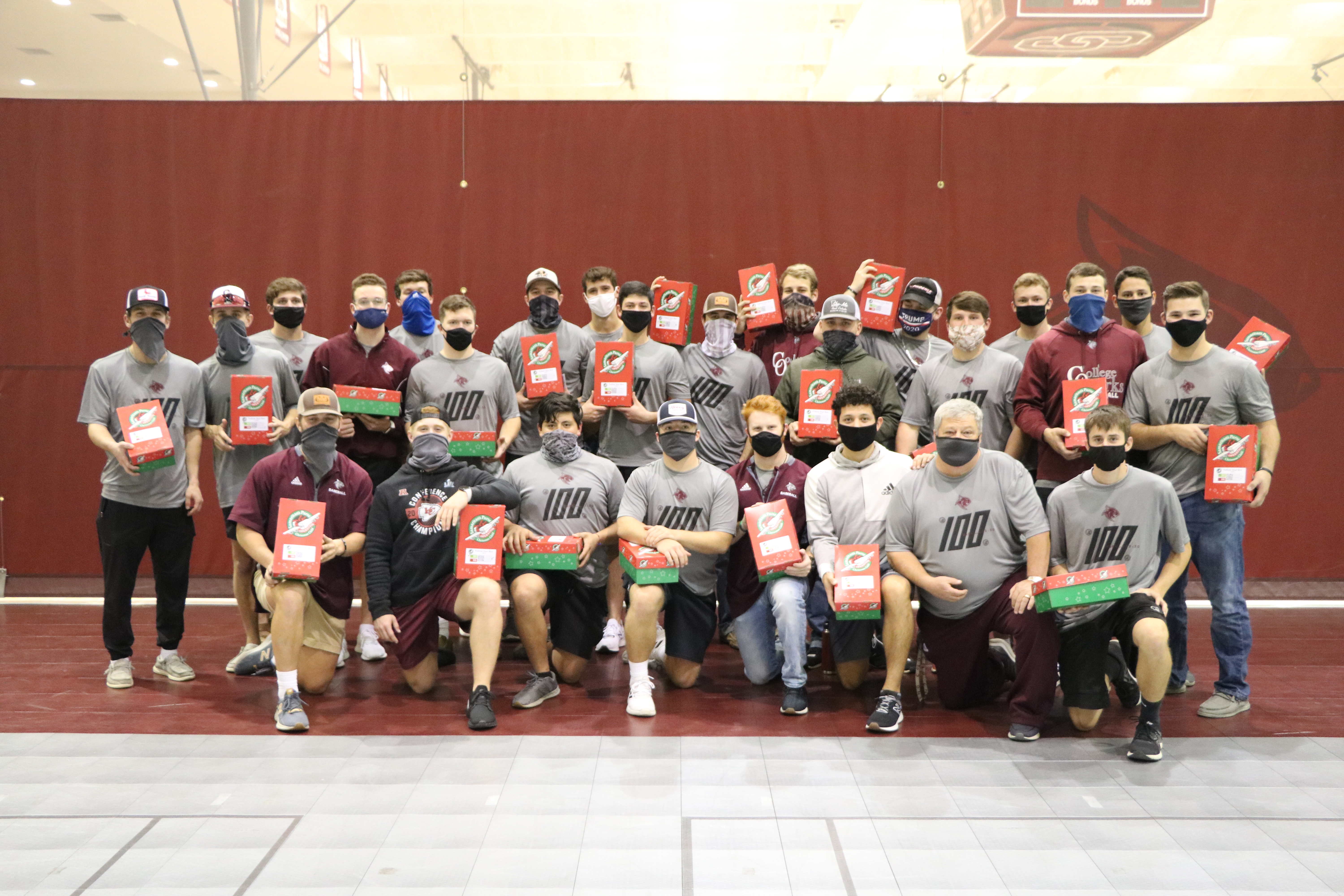 College of the Ozarks Men's Baseball team pose for photo with shoeboxes.